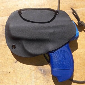 Peut inclure: Un &eacute;tui en cuir noir avec une fermeture &agrave; cordon et un pistolet bleu avec une poign&eacute;e noire.