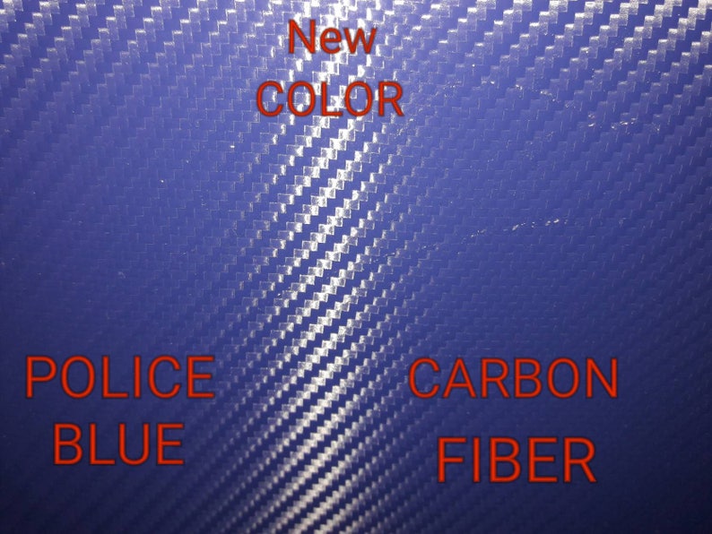 May include: A close-up of a blue carbon fiber material. The text "New Color" is written in red above the material. The text "Police Blue" is written in red below the material on the left. The text "Carbon Fiber" is written in red below the material on the right.