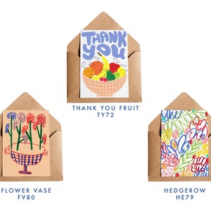 May include: Three greeting cards in brown envelopes. The top card says "THANK YOU" above a fruit bowl illustration. The middle card shows a flower vase design. The bottom card features a colorful floral pattern. Each card has a unique design.