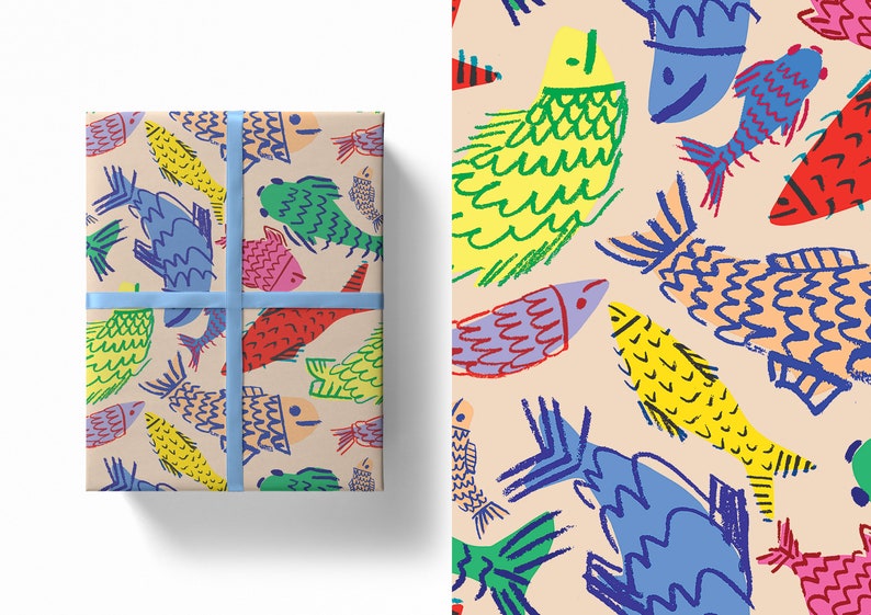 May include: Gift-wrapped package with a colorful fish pattern. The design features hand-drawn fish in shades of yellow, green, red, blue, and purple on a beige background. A light blue ribbon secures the package, creating a cheerful and artistic presentation.