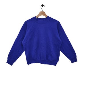 Sweat raglan vierge Fruit of the Loom des années 90 moyen vintage pull uni pull pull ras du cou bleu taille M