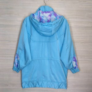 May include: A light blue hooded jacket with a floral print lining. The jacket has a zipper closure and two pockets.