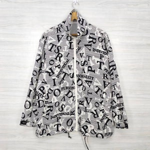 May include: A white zippered jacket with a black and white all-over print of the words "PERSONALITY", "INDIVIDUAL", "PERSON", and "IDENTITY".