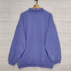 May include: A purple sweatshirt with a zippered collar and long sleeves.