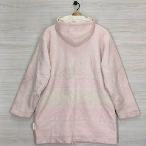 May include: A pink hooded jacket with a white and pink patterned design. The jacket is made of a soft, fuzzy material.