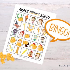 A Greek mythology bingo card is displayed on a wooden table. A pile of gold fish crackers sits next to the board with several pieces covering images on the board. Because five images across the board are covered, a word bubble reads, Bingo!
