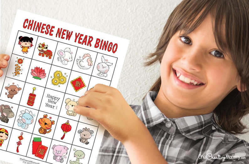 Boy proudly holding up a Lunar New Year bingo card