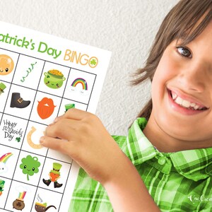 Boy proudly holding up a St. Patricks Day bingo card