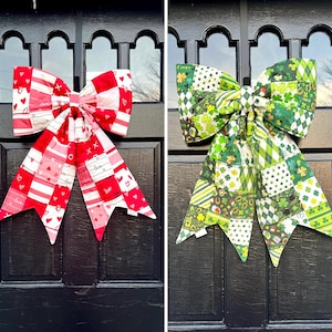 May include: Two large fabric bows. One bow features a patchwork design in red and white with hearts and the word "love". The other bow is green with a patchwork of shamrocks, polka dots, and other St. Patrick's Day themed patterns.