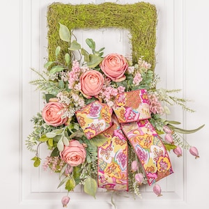 Moss covered wreath full of pink roses with designer bow is perfect for your front door every day.