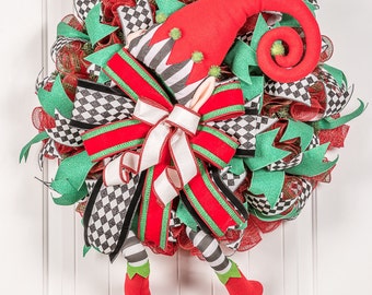 Christmas front door welcome wreath with red and green Elf legs is a mix of traditional colors with whimsy elf legs.