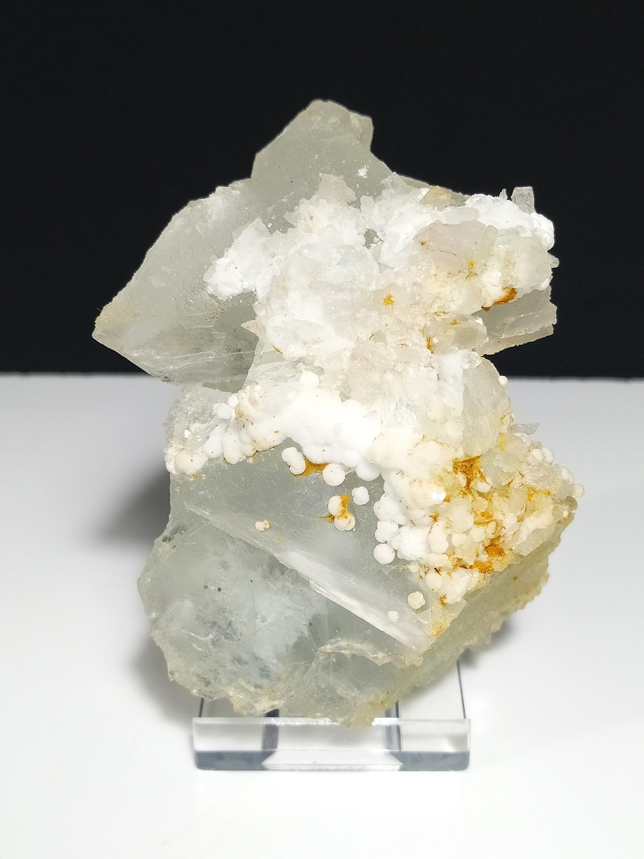 白いアラゴナイトの花 青とピンクの淡い色合いと白い薄片を持つ半透明の高級フロー