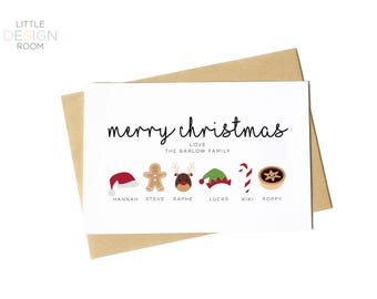 May include: A Christmas card with the words "merry christmas" in black script. Below the text are festive icons including a Santa hat, gingerbread man, reindeer, elf hat, candy cane, and mince pie. The card is on a brown envelope.