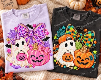 May include: Two t-shirts, one light purple and one charcoal gray, each featuring a graphic of a ghost holding a jack-o'-lantern. The purple shirt shows a ghost with a leopard print bow, while the gray shirt features a ghost in a baseball cap with a checkered bow.