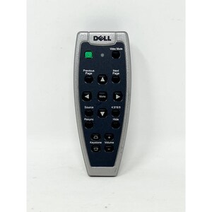 May include: A silver and black Dell remote control with multiple buttons, including "Video Mode," "Menu," and "Volume." The remote has a green power button and is designed for a projector or similar device.