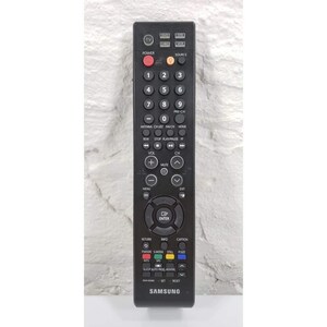 May include: Black Samsung TV remote control with numerous buttons for power, volume, channel selection, and menu navigation. Features a red power button, number keys, and function buttons. The brand name "SAMSUNG" is printed at the bottom.