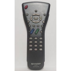 May include: A gray Sharp LCD TV remote control with multiple buttons, including volume, channel, and number keys. The remote has a red power button and the model number GA174WJSB is visible.