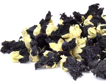 May include: A pile of dried hibiscus flowers, some are black and some are a pale yellow.