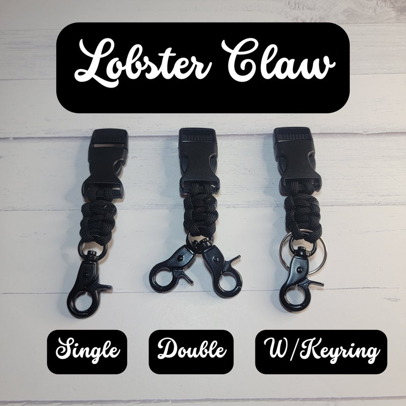 May include: Three black paracord lanyards with plastic side-release buckles. The first has a single lobster claw, the second has a double lobster claw, and the third has a lobster claw with a metal keyring. Text reads Lobster Claw, Single, Double, W/Keyring.