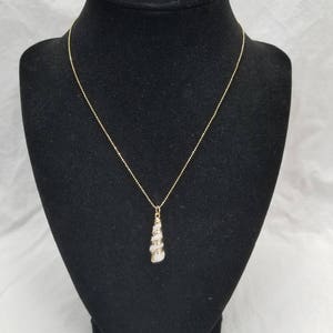 Dainty seashell pendant necklace gold electroplated.