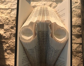Arte de livro dobrado com algema