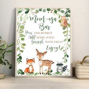 May include: A printable sign for a "Mom-osa Bar" with a woodland theme. The sign features a deer, fox, raccoon, and owl surrounded by greenery. The text reads "Mom-osa Bar", "Pour the bubbly", "Add some juice", "Garnish with fruit", and "Enjoy!"