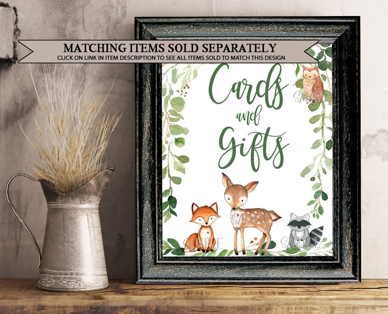 May include: A printable sign with a white background and green foliage border. The sign says "Cards and Gifts" with a cute fox, deer, and raccoon illustration.