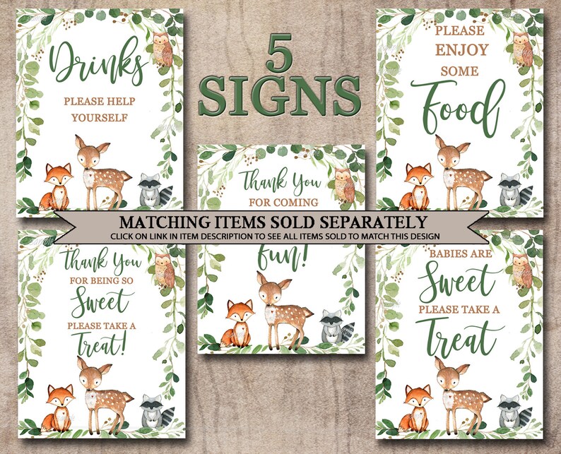May include: Five printable signs with a woodland theme. The signs feature a deer, fox, and raccoon with green foliage. The text on the signs reads: "Drinks, Please Help Yourself", "Thank You For Coming", "Fun!", "Babies Are Sweet, Please Take A Treat", and "Please Enjoy Some Food".