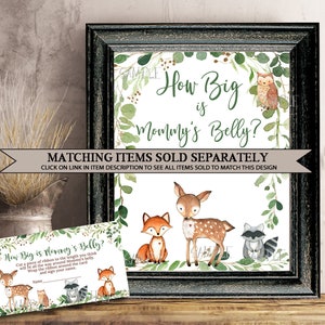 May include: A printable baby shower game card with a woodland theme. The card features a deer, fox, raccoon, and owl with green foliage. The text on the card reads "How Big is Mommy's Belly?" and "Cut a piece of ribbon to the length you think will fit all the way around Mommy's belly. Wrap the ribbon around the card and sign your name."
