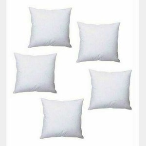 May include: Five white square pillow inserts. The pillow inserts are made of a soft, white fabric and are perfect for adding comfort and support to your favourite pillows.
