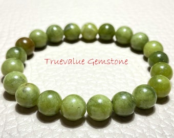May include: A green gemstone bracelet with 18 round beads. The bracelet is made of natural stone and has a polished finish.  Truevalue Gemstone.