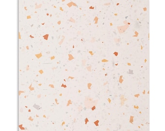 May include: A white background with a terrazzo pattern featuring small, irregular shapes in shades of orange, peach, and gray.