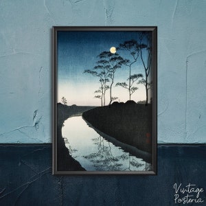 May include: A black and white woodblock print of a Japanese landscape with a river winding through a forest under a full moon. The moon is a bright yellow circle in the dark blue sky. The trees are silhouetted against the sky.