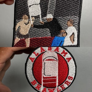 May include: Embroidered patch featuring a red circle with a white chair inside, surrounded by a silver ring with the text "ALABAMA BRAWLERS".
