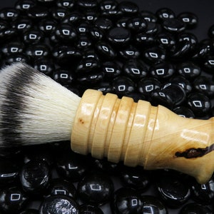 Handcrafted wood shaving brush made from Ash with olive flecks featuring a silvertip synthetic bristle knot. For traditional wet shaving.