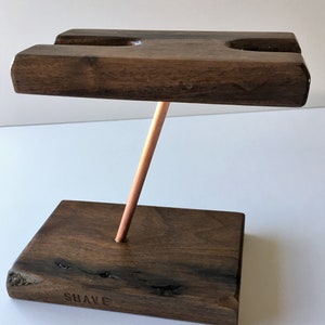 Handcrafted Black Walnut shaving stand on a copper upright. That holds wet shave razor and brush.