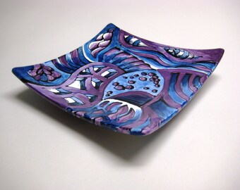 Small hand painted ceramic plate in blues and purples