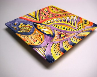 Hand painted ceramic plate in yellows, oranges and purples