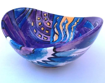 Hand painted small ceramic "swoop" bowl in purples, blues and orange