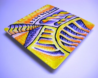 Hand painted glazed plate in yellows, oranges and purples