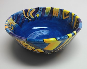 Hand painted ceramic 8" diameter by 3.3" bowl in blues, yellows and oranges