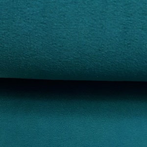 Könnte beinhalten: Nahaufnahme eines tealblauen Stoffes mit weicher, flauschiger Textur.