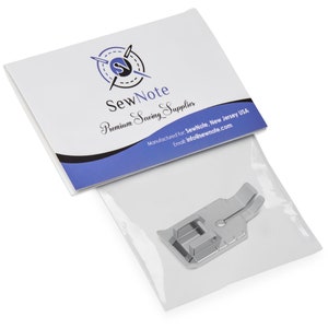 May include: A silver sewing machine foot with a small hole in the center and two prongs on the right side. The foot is packaged in a clear plastic bag with a white paper label that reads "SewNote Premium Sewing Supplies".