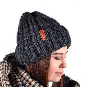 May include: A dark gray knitted beanie with a brown leather patch that says "Fall in love with nature".
