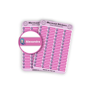 May include: Two sheets of pink mermaid stickers with the name "Alexandra" printed on them. Each sticker features a mermaid illustration and the text "Alexandra". The stickers are labeled "Mermaid Stickers" and "Made in the UK".