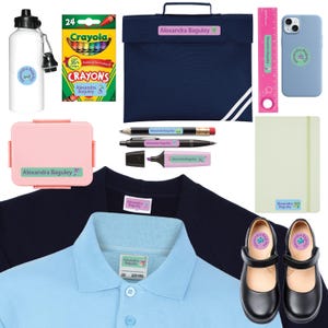 May include: A collection of school supplies and accessories, including a water bottle, crayons, a lunchbox, a ruler, a phone case, a notebook, pens, a highlighter, a navy blue blazer, a light blue polo shirt, and black Mary Jane shoes. Each item is labeled with "Alexandra Baguley".