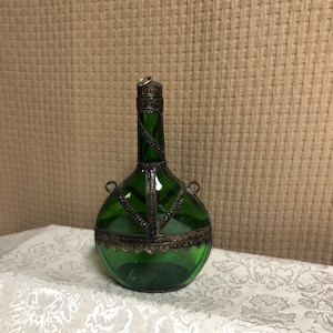 Old Bottle Adorned With Antique Metal