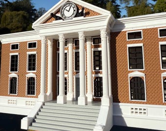 May include: A detailed model of a brick building with white columns and a clock tower. The building has a white facade with a gray staircase leading up to the entrance. The clock face is black with white hands and Roman numerals.