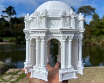 May include: A white 3D printed model of the Palace of Fine Arts in San Francisco. The model is detailed and includes the columns, arches, and dome of the original structure.