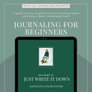 May include: A green tablet computer screen with the text "Journaling for Beginners" and "Welcome to Just Write It Down". The screen also features a photo of a woman sitting with a dog.
